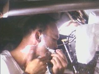 Mike Collins shaving on board Apollo 11